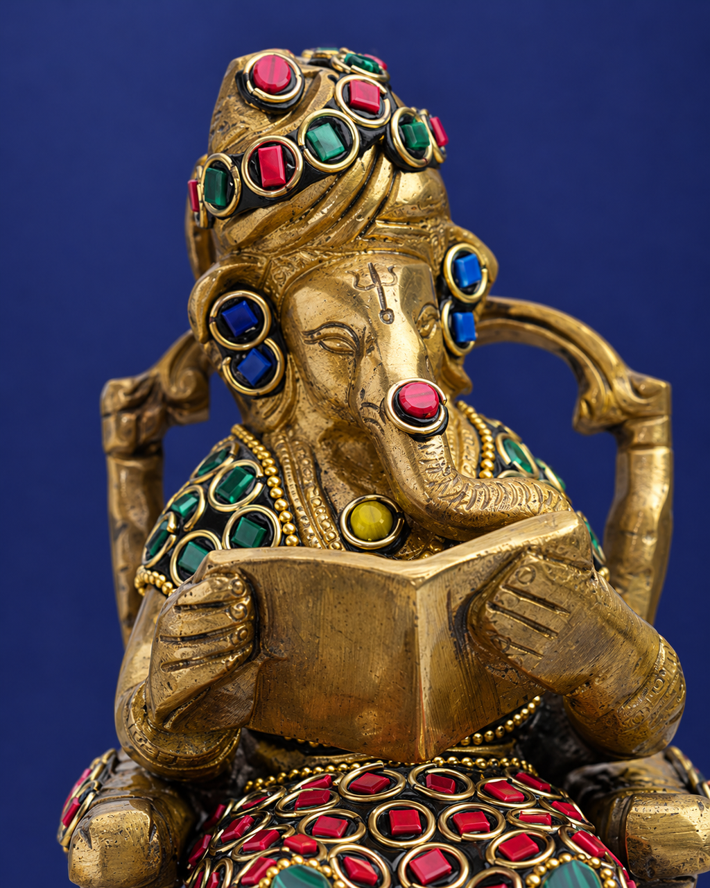 Brass Ganesha Reading on Recliner with Inlay Work — Craft detail