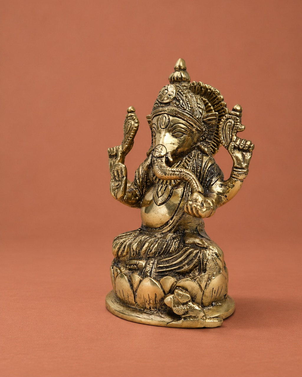 Brass Chaturbhuj Ganesha on Lotus Base — Three-quarter hero